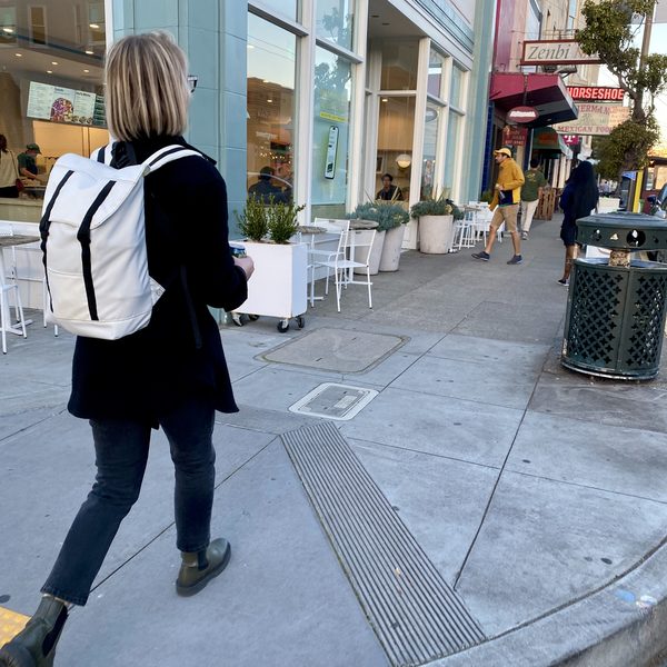 Heather sporting the Eleven Fifteen Daypack in white