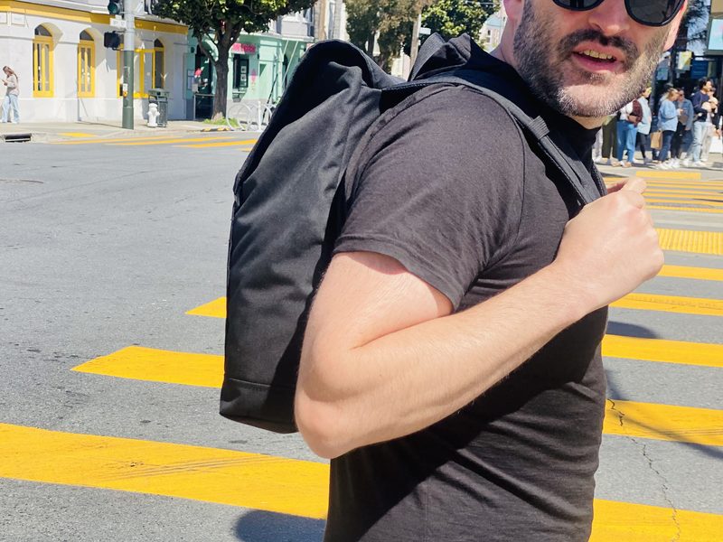 Kevin using the Eleven Fifteen Daypack in black near the Castro in San Francisco